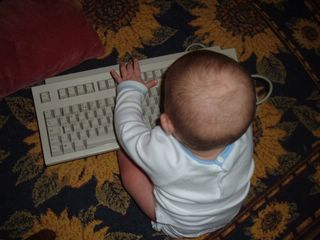 Foto de un bebé con un teclado de ordenador